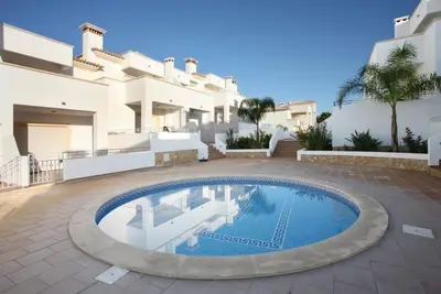 a large swimming pool in front of a house at Thiago Holidays Apartment in Albufeira