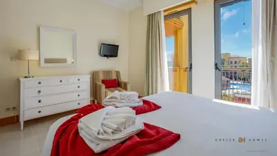 a bedroom with a bed and a dresser and a window at Greice Homes- 3 bed Luxury Apartment in Vilamoura in Quarteira