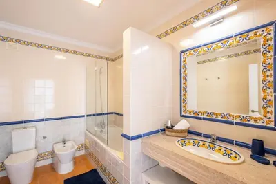 a bathroom with a sink toilet and a mirror at Gale SunBeach Village - Jardins da Gale in Albufeira