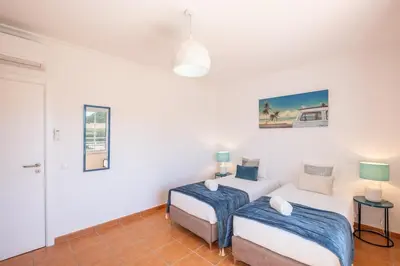 two beds in a room with white walls at Gale SunBeach Village - Jardins da Gale in Albufeira