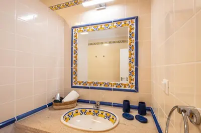 a bathroom with a sink and a mirror at Gale SunBeach Village - Jardins da Gale in Albufeira