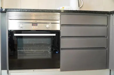 a kitchen with an oven with its door open at Villa Catarina Ocean View in Albufeira
