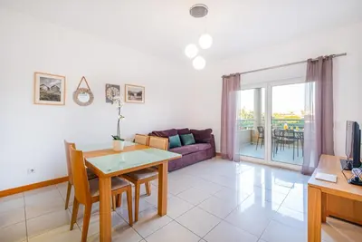 a living room with a table and a couch at Barracuda Oura Dream Apartment in Albufeira