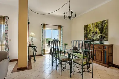 a dining room with a table and chairs at Villa Jonas in Albufeira