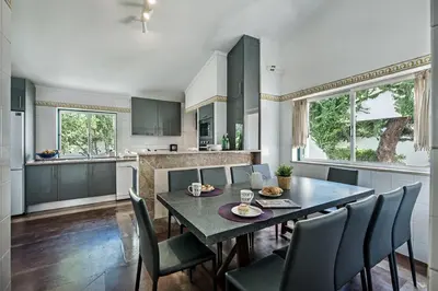 a dining room with a table and chairs in a kitchen at Villa Jonas in Albufeira