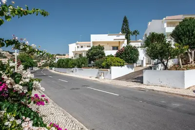 an empty street in a town with white buildings at Villa Jonas in Albufeira
