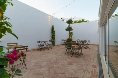 a patio with tables and chairs in a room at Atlantic Bliss in Albufeira