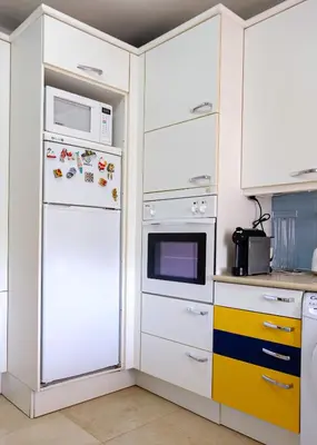 a kitchen with a white refrigerator and microwave at Carpe Diem Vilamoura By Dualhotels in Vilamoura