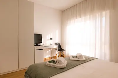 a bedroom with a bed with towels on it at Carmo House in Faro