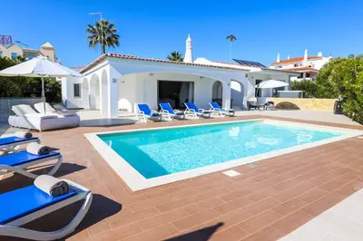 a swimming pool in front of a villa at Villa Namora in Albufeira
