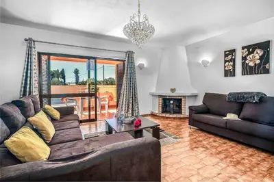 a living room with a couch and a fireplace at Casa Pluma in Albufeira