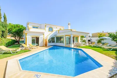 a large swimming pool in front of a house at Villa Jeanic in Galé