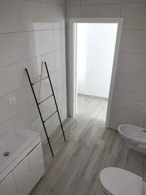 a white bathroom with a toilet and a sink at CASA CANELAS in Faro
