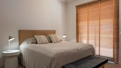 a bedroom with a bed and two lamps and a window at Villa Pinetree Seaside, Albufeira in Albufeira