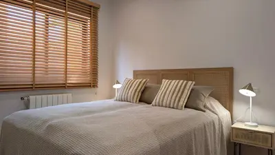 a bedroom with a bed with two pillows and a window at Villa Pinetree Seaside, Albufeira in Albufeira