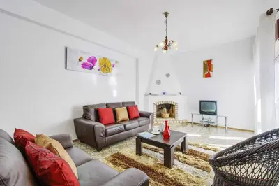 a living room with a couch and a fireplace at Casa Barreto in Albufeira
