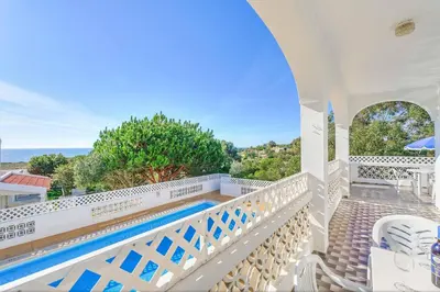 a villa with a swimming pool and a balcony at Casa Barreto in Albufeira