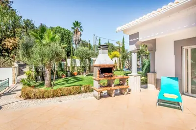 a house with a outdoor oven in a yard at Villa Paris in Terras Novas