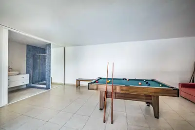 a living room with a pool table in it at Villa Paris in Terras Novas