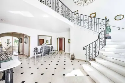 a staircase in a home with white walls and white floors at Villa Paris in Terras Novas
