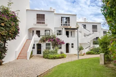an exterior view of a white house with stairs at Seaside Retreat with Pool, AC, and Fast Wi-Fi in Albufeira