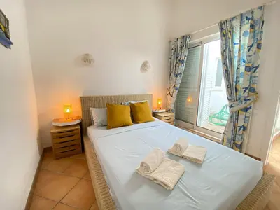 a bedroom with a bed with two towels on it at Albufeira Quinta da Balaia Charming by Homing in Albufeira