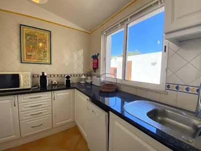 a kitchen with a sink and a large window at Albufeira Quinta da Balaia Charming by Homing in Albufeira