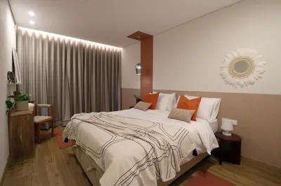 a bedroom with a large bed with orange pillows at Blue over blue in Quarteira