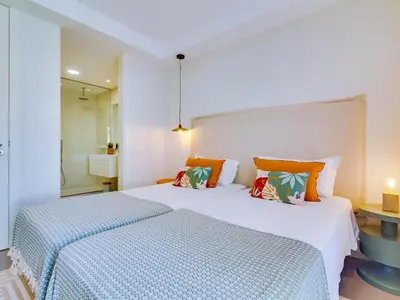 two beds in a hotel room with two beds sidx sidx sidx at AL - Boho Chic Villa Country Club in Vilamoura