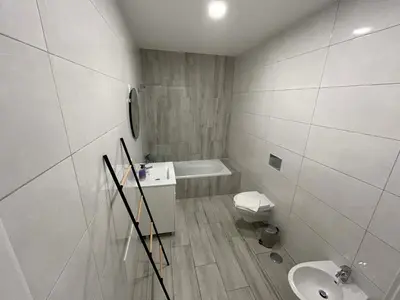 a white bathroom with a toilet and a sink at CASA ANALUCIA in Faro