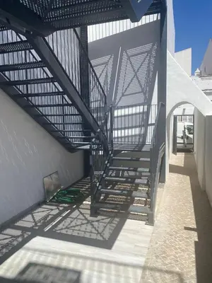 a stairway leading up to a building with a metal structure at CASA ANALUCIA in Faro