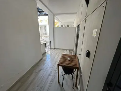 a room with a wooden table and a chair at CASA ANALUCIA in Faro