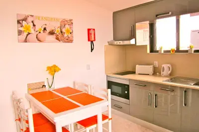 a small kitchen with a table and chairs in a room at Casa da Horta, Vale carro Olhos de Agua in Albufeira