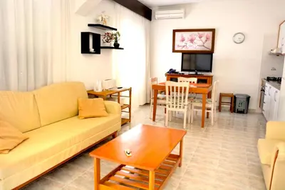 a living room with a couch and a table at Casa da Horta, Vale carro Olhos de Agua in Albufeira