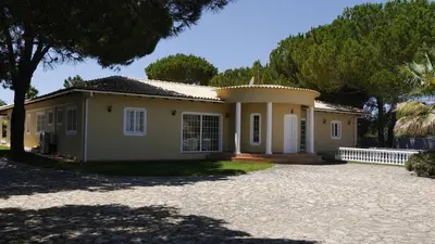 a bathroom with a toilet and a sink and a window at Villa with pool children Very welcome Algarve Portugal for 10 people in Quarteira