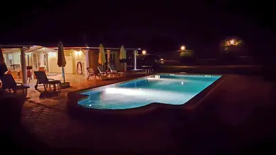 a yard with pillars in front of a house at Villa with pool children Very welcome Algarve Portugal for 10 people in Quarteira
