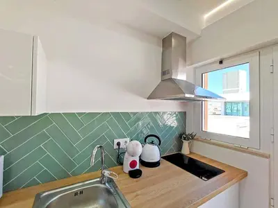 a kitchen with a sink and a counter top at Lovely Terrace Studio Baixa Faro in Faro