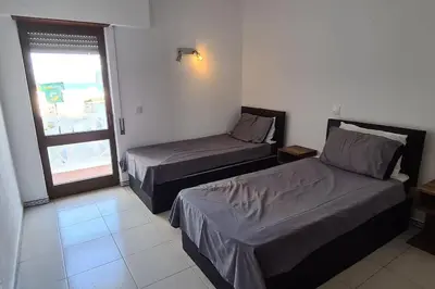 a hotel room with two beds and a window at 403 - Oura - 2 bedroom- Sea View in Albufeira