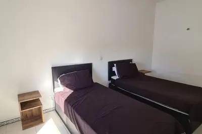 two beds sitting next to each other in a room at 403 - Oura - 2 bedroom- Sea View in Albufeira