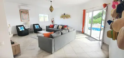 a living room with a couch and a table at Villa Arquete 6 seat Jacuzzi 5 min walk to shops in Guia