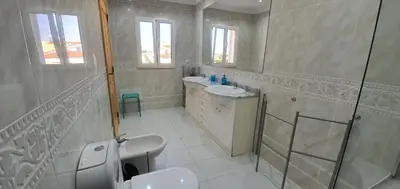 a white bathroom with two sinks and a shower at Villa Arquete 6 seat Jacuzzi 5 min walk to shops in Guia
