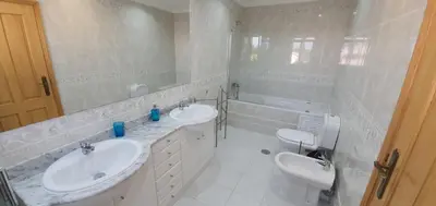 a white bathroom with two sinks and a mirror at Villa Arquete 6 seat Jacuzzi 5 min walk to shops in Guia