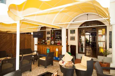 a restaurant with a large umbrella over a table at Two bed Old Village E007 in Vilamoura