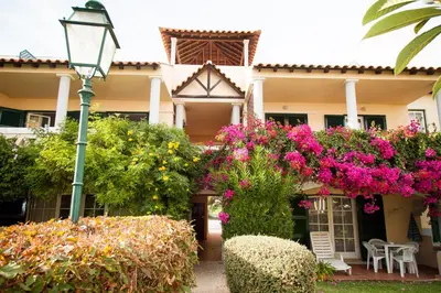 a building with flowers and a street light at Two bed Old Village E007 in Vilamoura