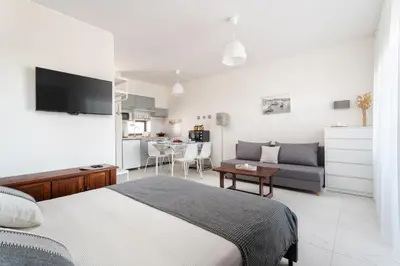 a kitchen and dining room with a table and chairs at BnB Homes Jardim Cozy Apartment with 3 Swimming pools near the Old Town in Albufeira