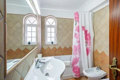 a bathroom with a sink and a toilet and a tub at 7 Bedroom Private Villa Tenazinha II, with pool in Albufeira