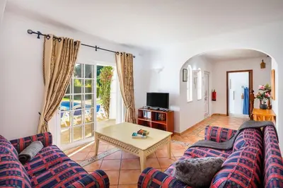 a living room with a couch and a table at 7 Bedroom Private Villa Tenazinha II, with pool in Albufeira