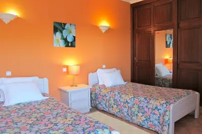 a bedroom with two beds and a mirror at 7 Bedroom Private Villa Tenazinha II, with pool in Albufeira