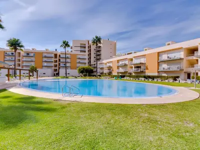 an image of a swimming pool in front of a building at AL - Apartamento Moura Praia in Vilamoura