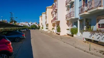 a street with cars parked on the side of a building at Serene Apartment W/ Balcony and Pool by LovelyStay in Quarteira
